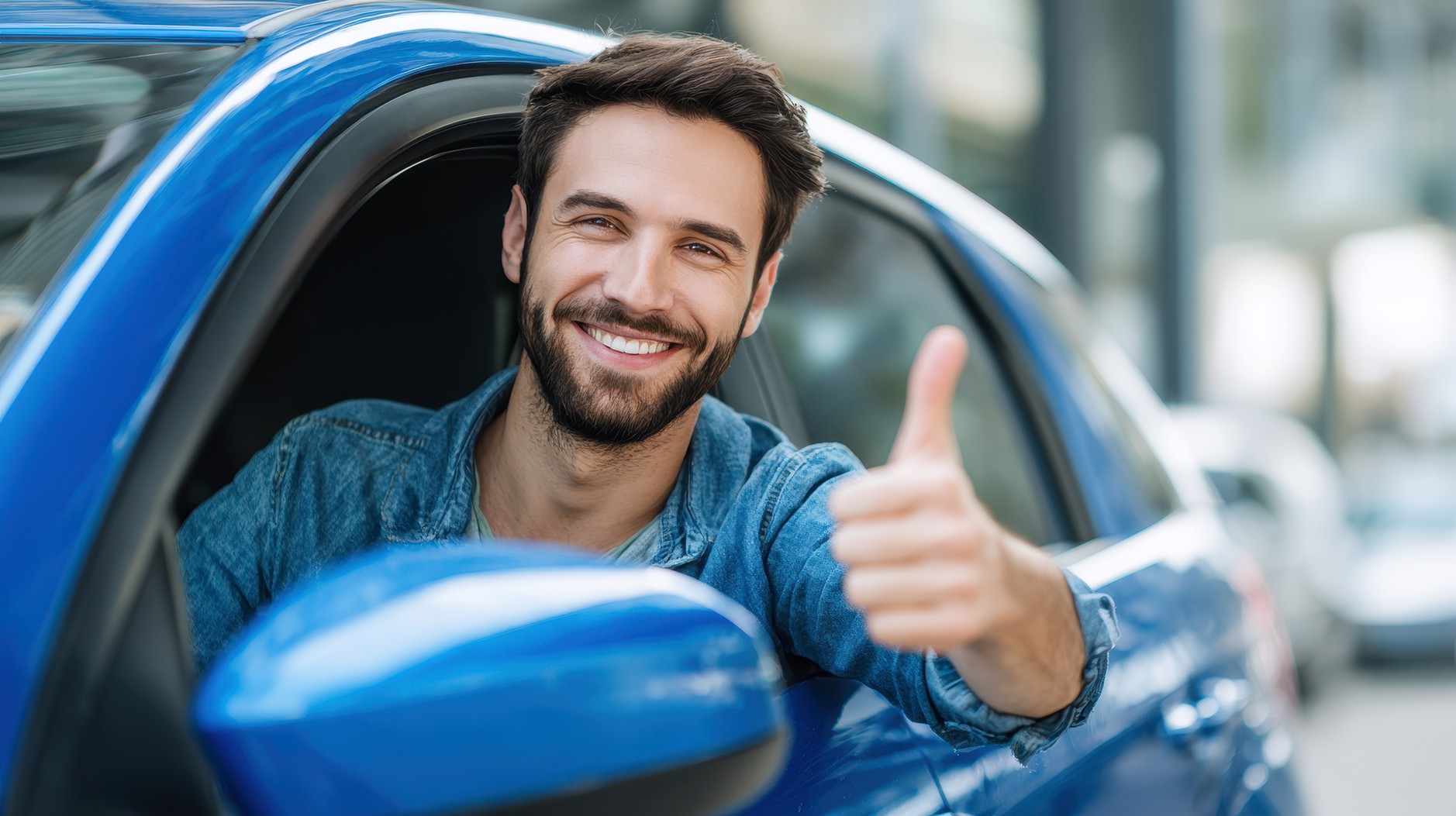 A happy man giving a thumbs up from his blue car, representing confidence in choosing the right motor warranty or mechanical breakdown insurance in South Africa